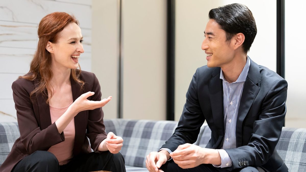 Men and women talking casually in an open office space