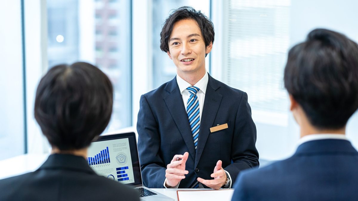 手を動かしながら資料の説明をする男性