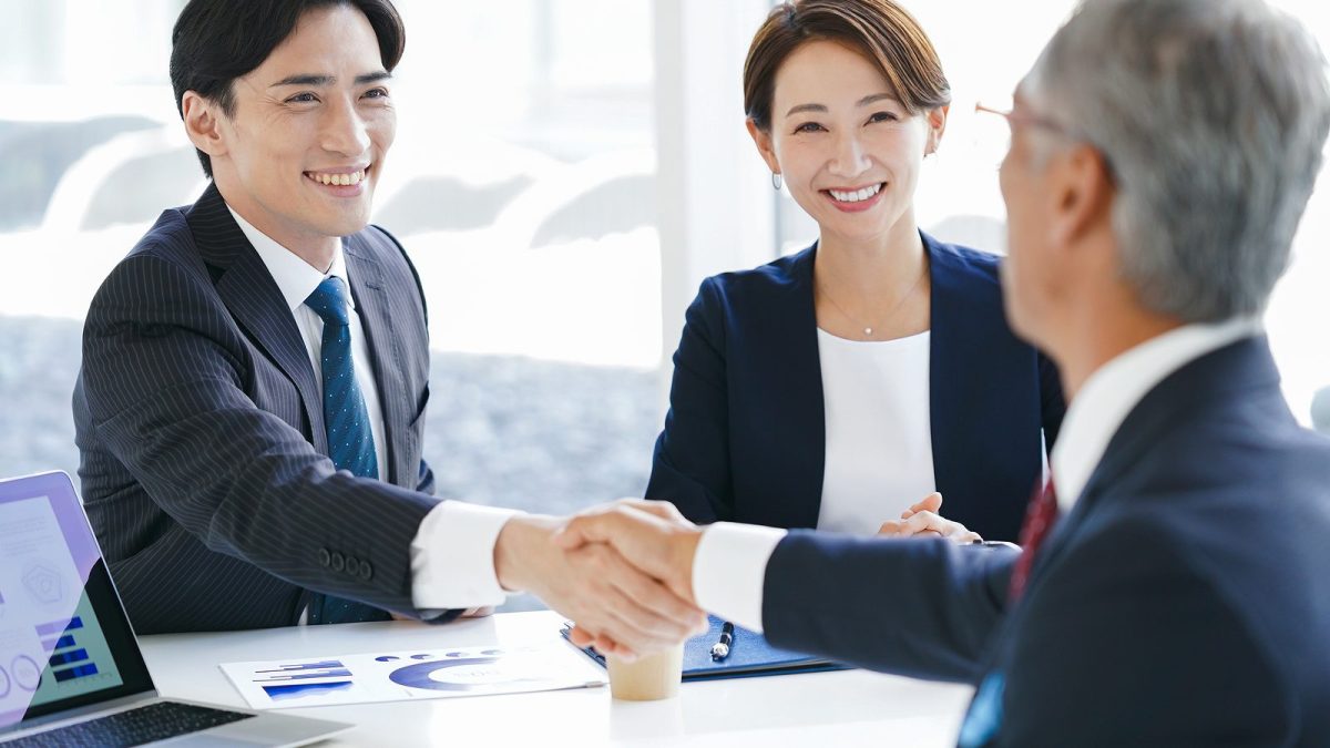 Two men in suits shaking hands