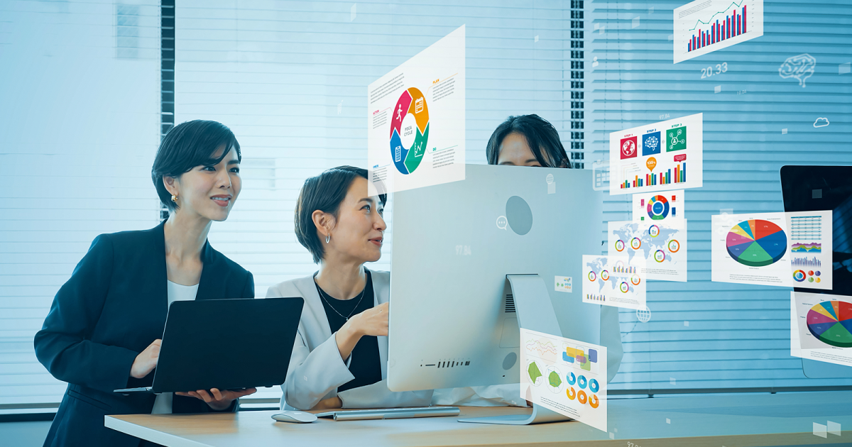 モニターに資料を映しながら話し合う女性