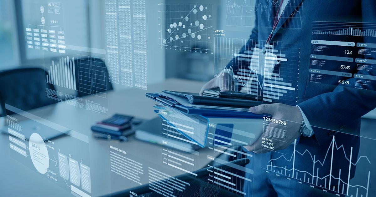 ファイルやバインダーを重ねて持ち歩く男性